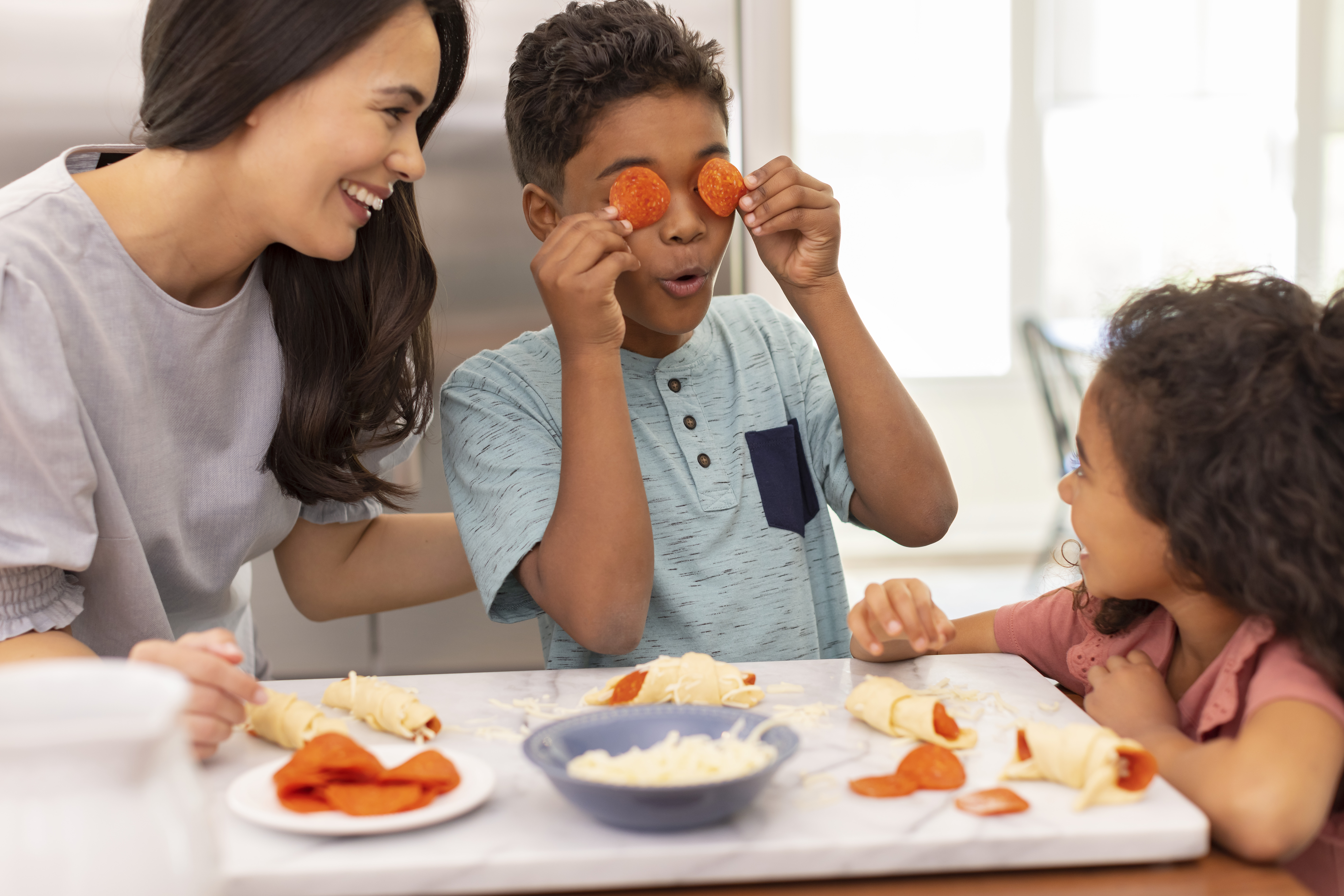 Family making pizza crescent rolls